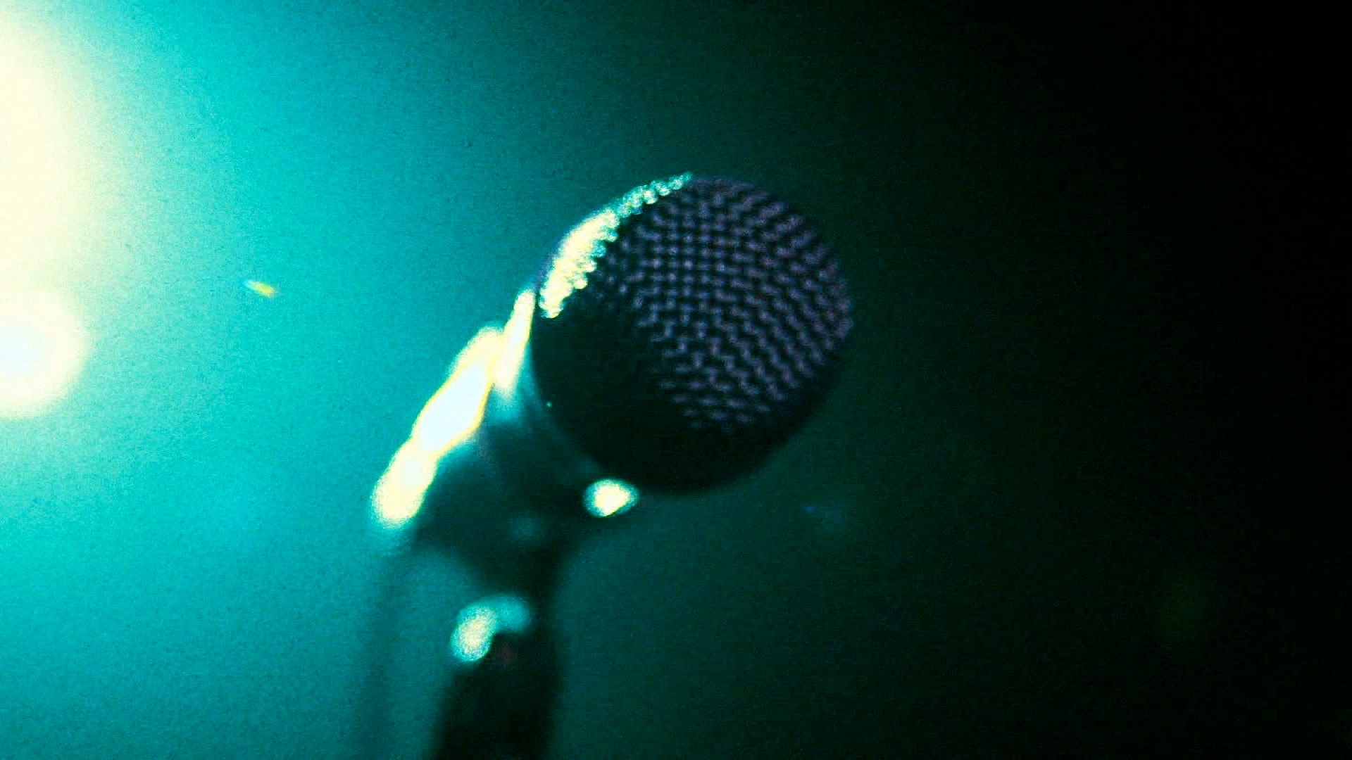 Microphone with teal stage lighting