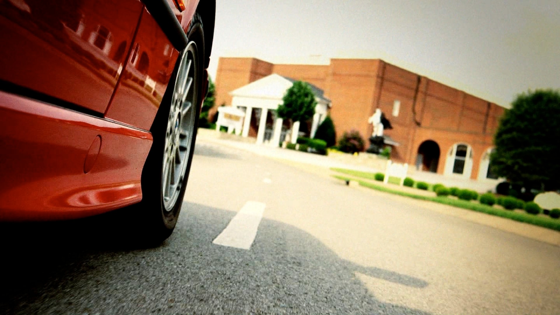 Red car low angle on parking lot